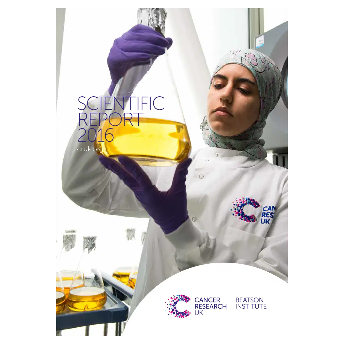 A scientist in a lab coat and headscarf examines a large flask of yellow liquid in a laboratory. Scientific Report 2016 and Cancer Research UK Beatson Institute logos are visible on the cover.