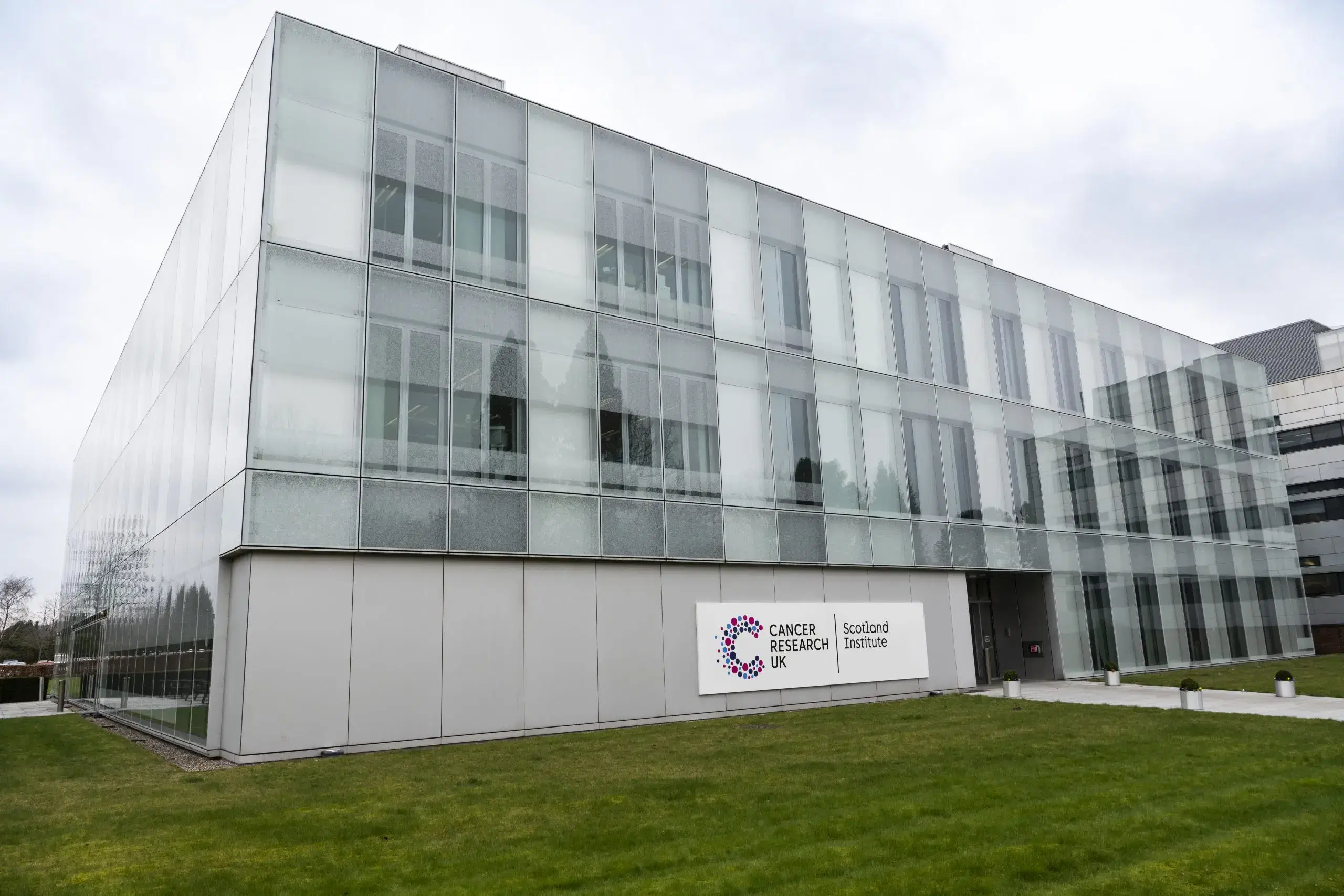 The Institute's glass-fronted building at Garscube, with signage reading Cancer Research UK Scotland Institute