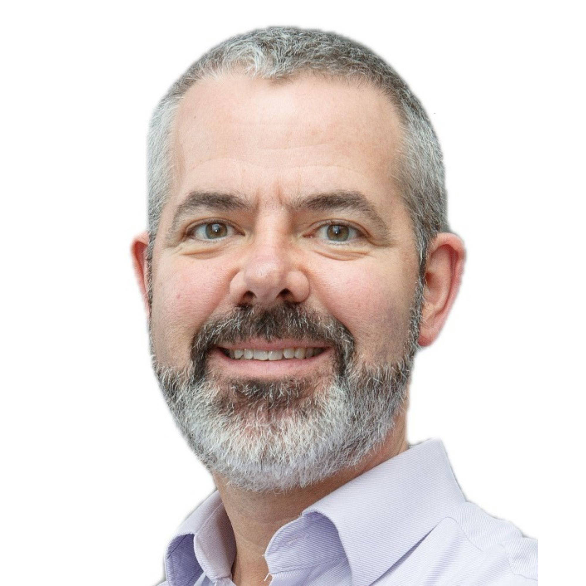 A headshot of a middle-aged man with short greying hair and a beard, smiling at the camera.